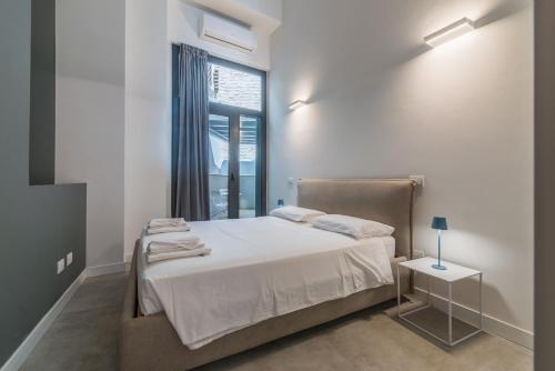 a bedroom with a bed and a window at Effealatapartments - EdenLoft in Senigallia