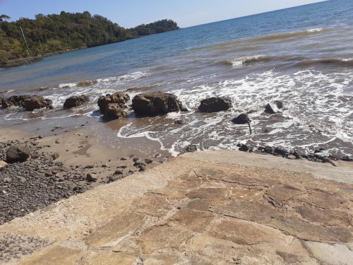 a beach with some rocks in the water at Villa Armor in Nosy Be