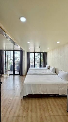 a large bedroom with a large bed and large windows at Chillax in Ha Long