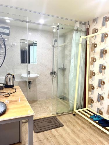 a shower stall in a bathroom with a sink at Chillax in Ha Long