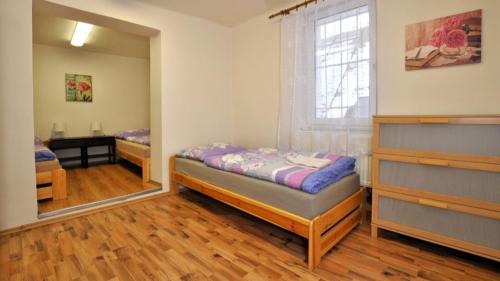 a bedroom with two beds and a mirror at Apartmán HB in Havlíčkŭv Brod