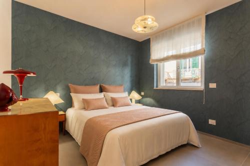 a bedroom with a large bed and a window at Wanderlust Experience Mood Apartment in Bitonto