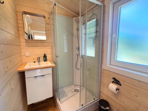 a bathroom with a shower and a sink at Älg Stuga in Kosta