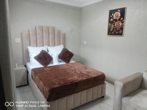a bedroom with a bed with a large headboard at The Hush House in Roodepoort