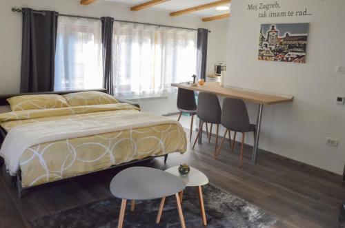 a bedroom with a bed and a table and chairs at In-N-Out Ilica in Zagreb