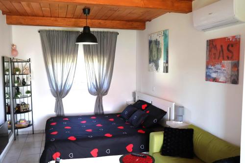 a living room with a bed and a couch at Kuća za odmor PICCOLINA in Vinica