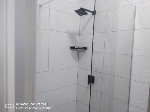 a shower with a glass door in a bathroom at The Hush House in Roodepoort