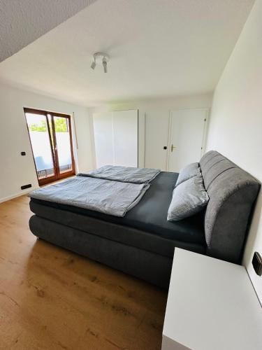 a bedroom with a large bed in a room at FeWo Ruf in Sasbach am Kaiserstuhl