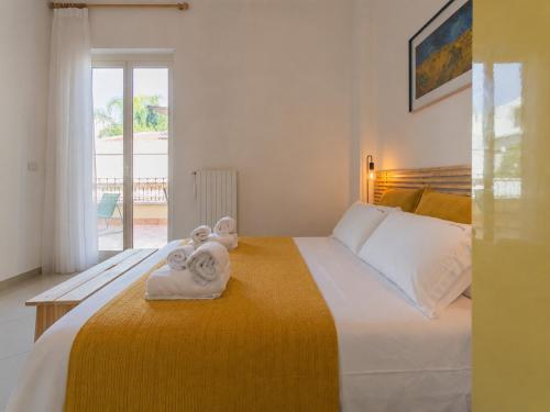 a bedroom with a bed with towels on it at Wanderlust Experience La Casetta in Bitonto