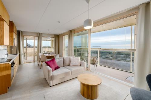 a living room with a couch and a table at Marina Resort Apartments by Hiekka Booking in Kalajoki