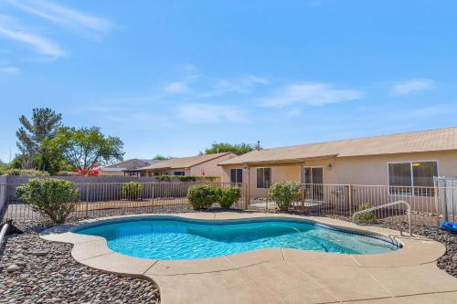 a swimming pool in front of a house at Peaceful Valley in Tucson