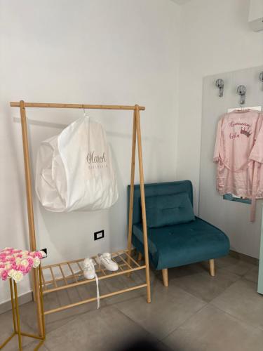 a room with a blue chair and a white bag at Paradise Rooms in Ripabottoni