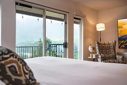a bedroom with a bed and a large window at Mountain Retreat Hope in Hope