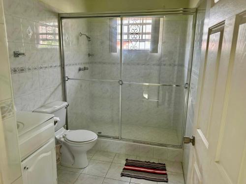 a bathroom with a shower and a toilet at Tropical Retreat - by ZenBreak in Saint Peter