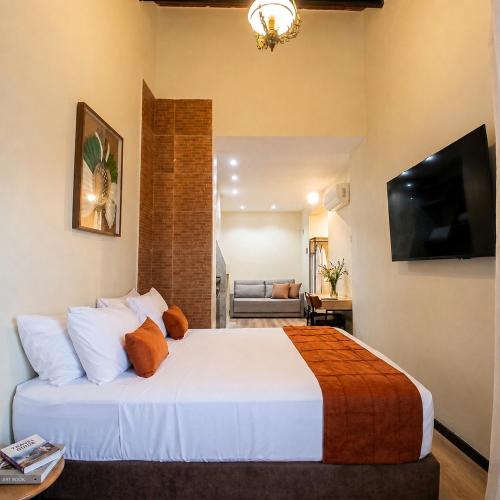 a bedroom with a large bed and a living room at Cozy House in Rio de Janeiro