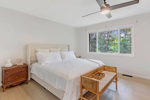 a white bedroom with a bed and a window at Modern 3BR With Big Kitchen & TV Rm in State College