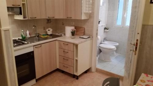 a small kitchen with a sink and a toilet at Casa Vacanze Nonno Giulio in Rome