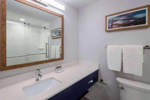 a bathroom with a sink and a mirror and a toilet at Cape Cod Family Resort and Parks in West Yarmouth