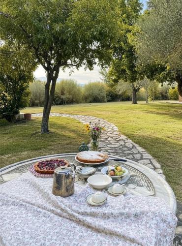 a table with plates of food on top at Audaces Resort in Recanati