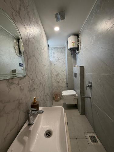 a bathroom with a sink and a toilet at The Green Hush in Rājpur