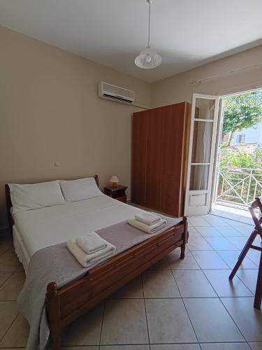 a bedroom with a bed with two towels on it at Ta Adelfia in Pylos