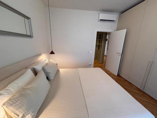 a white bed with white pillows in a room at Modern Apartment Empoli in Empoli