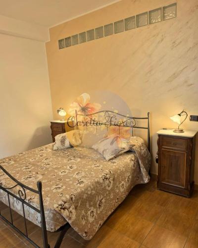 a bedroom with a bed with a sign on it at Casettafiore in Civitavecchia