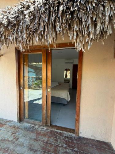 a view of a room with a bed and a window at Beco do Mar Jeri in Jericoacoara