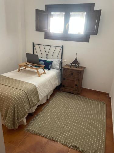 a bedroom with a bed with a laptop on it at Casa Valero in Rubielos de Mora