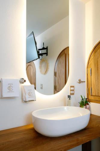 a bathroom with a white sink and a mirror at Hotel Casa Eteca in San Pedro y San Pablo Etla