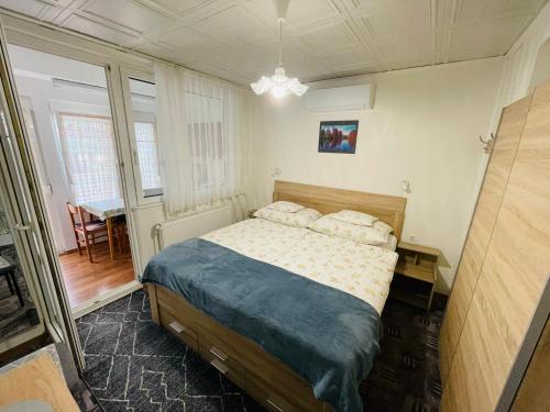 a bedroom with a bed with two pillows on it at Karolin Apartman in Bükfürdő