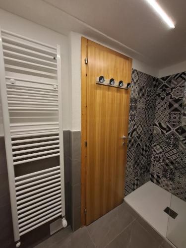 a bathroom with a wooden door in a room at Casa Cris SoleAlto in Marilleva