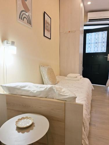 a small room with a bed and a table at il tesorino di Corfu in Corfu