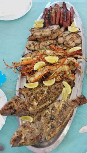 a plate of food with seafood on a table at Sweet Beach Bungalow in Tamarin