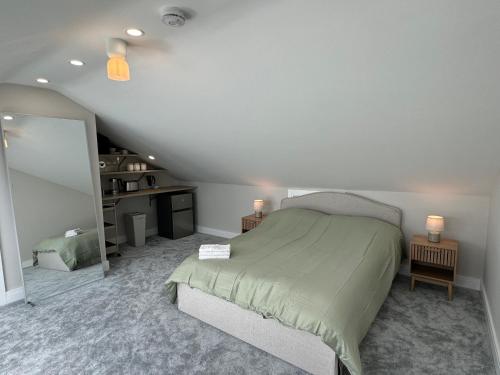 a bedroom with a large bed in a attic at Coastal Skylight Studio in Bettystown