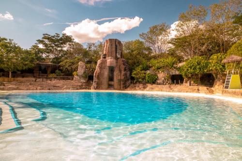 a pool at a resort with blue water at Güembé Hotel Lodge & Resort in Santa Cruz de la Sierra