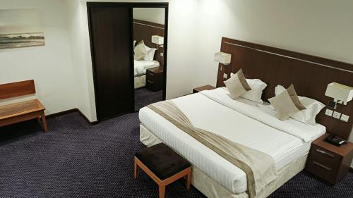 a hotel room with a large bed and a mirror at فندق دولف in Al Khobar