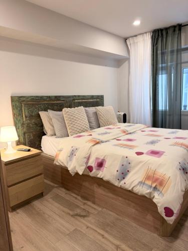 a bedroom with a large bed and a window at Blue rooms in Bilbao