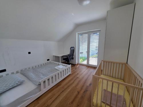 a bedroom with a bed and a desk and a chair at Private House with Jacuzzi and Sauna in Domžale