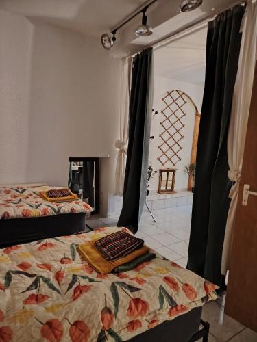 a bedroom with two beds and a fireplace at Studio Kyllburg-Eifel in Kyllburg