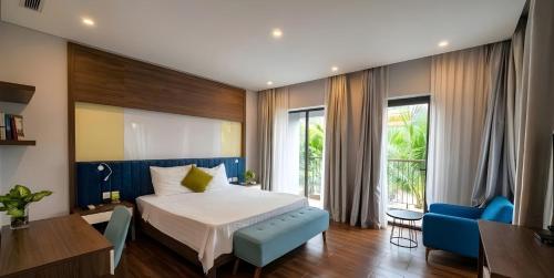 a hotel room with a bed and a blue chair at MT Luxury Villas Phu Quoc in Phú Quốc