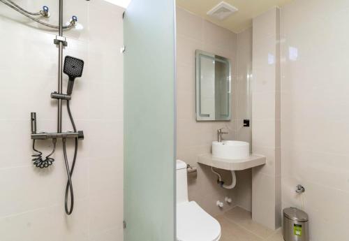 a bathroom with a shower and a toilet and a sink at White Sand Maldives in Ukulhas