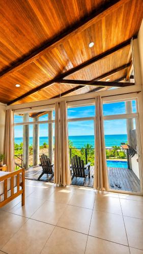 a living room with a view of the ocean at Laola Surf Residence in El Sunzal