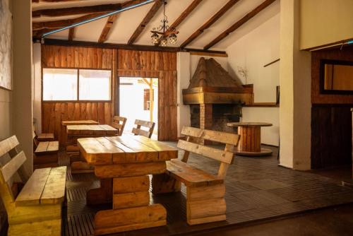a dining room with wooden tables and a fireplace at Bikers camp in Poreč
