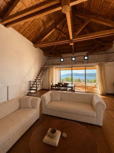 a living room with two couches and a table at Sea & Salt ,Pelion,Agria Volos in Agria