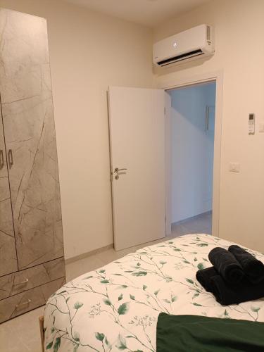 a bedroom with a bed and a walk in shower at חלון לגליל העליון in Beit Hillel