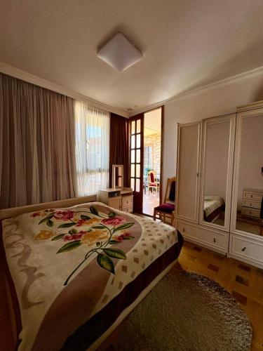 a bedroom with a large bed with a flower pattern on it at Qobuleti, Rustaveli street 162 e in Itʼkhvisi