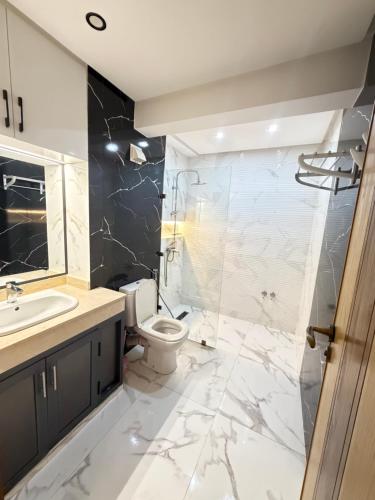 a bathroom with a sink toilet and a shower at Assafa in Agadir