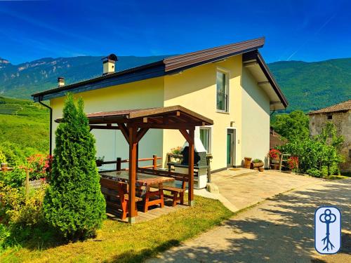 a house with a deck and a roof at Casa Vacanze Antico Eremo, tra natura e tradizione in Campodenno