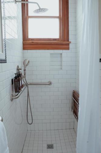 a bathroom with a shower with a window at The Mansard House in Galveston